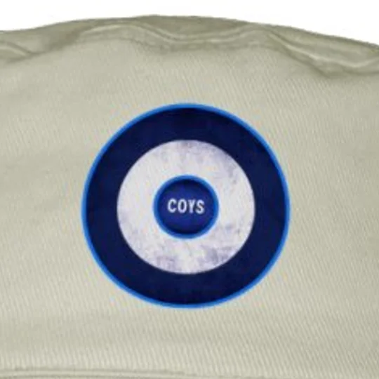Close-up of the COYS Mod target design on a sand-coloured retro football bucket hat