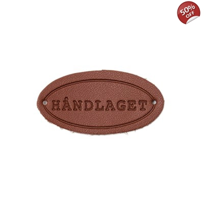Skinn merke med tekst "Håndlaget"