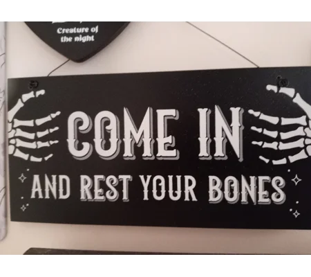 Come in and rest your bones hanging sign