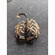 Black and gold coloured scorpion pin brooch