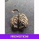 Black and gold coloured scorpion pin brooch