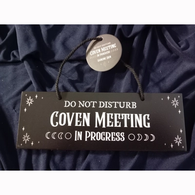 Coven meeting in progress sign