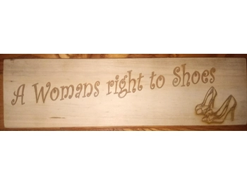 Wooden "A WOMAN'S RIGHT TO SHOES" sign.