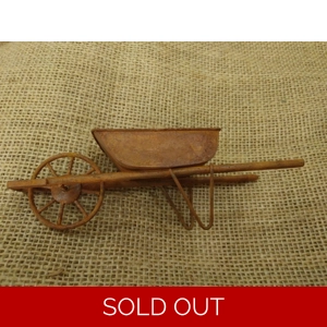 Miniature medium size rusty metal wheelbarrow