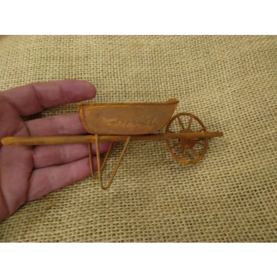 Miniature medium size rusty metal wheelbarrow