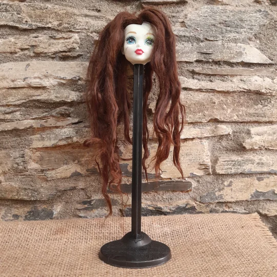 dark brown suri on a doll