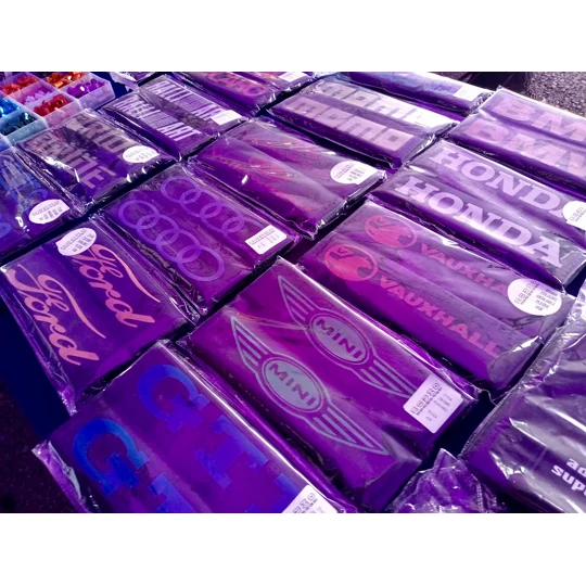 an angled view of available seat belt pad covers with printing for various designs. available in various designs and colours