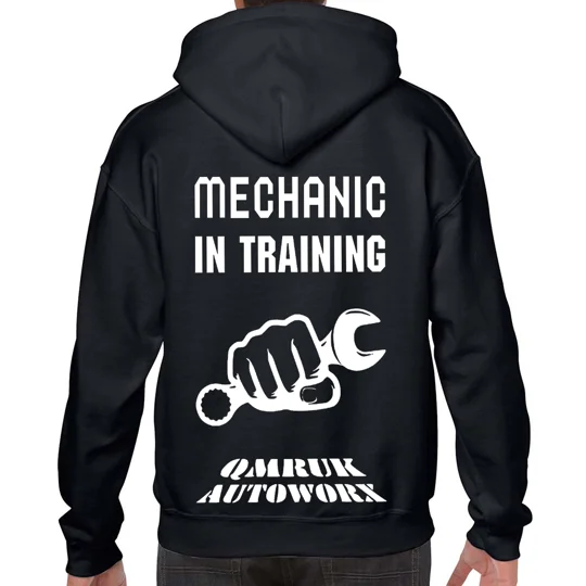 black hoodie with white text and imagery. reads mechanic in training and a fist holding a spanner with qmruk autoworx logo at the base