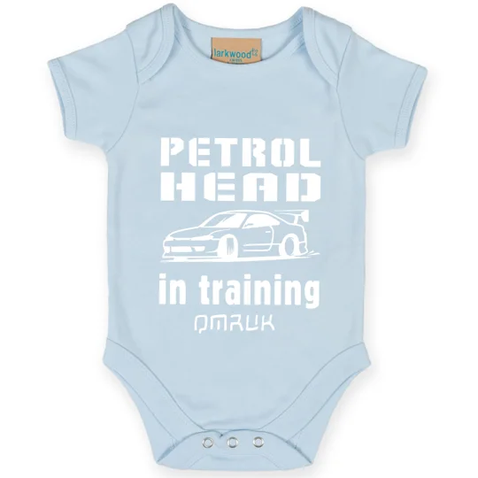 light blue babygrow onesie with black printed text reading little petrolhead in training and an image of a car all printed in white