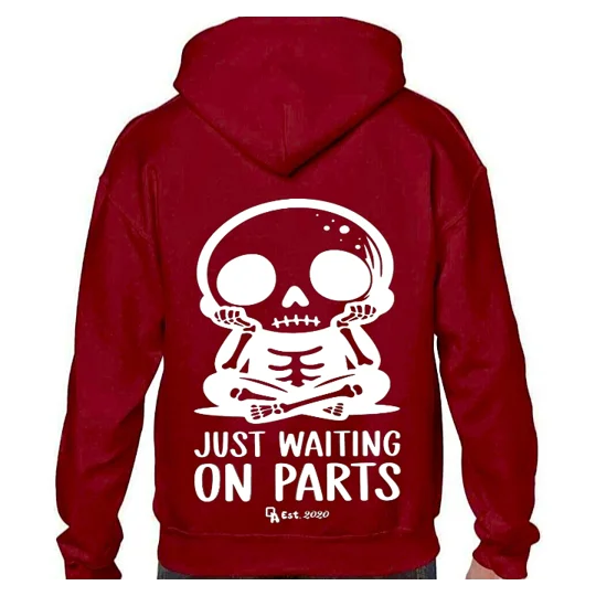 dark red hoodie with white printed image and text. a cute skeleton sitting with legs crossed and hands on chin with text reading waiting on parts