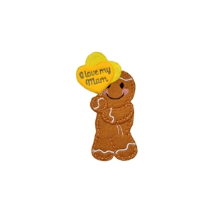A felt gingerbread character holding two yellow heart-shaped balloons, with the front balloon stitched with the words “I love my mam”.