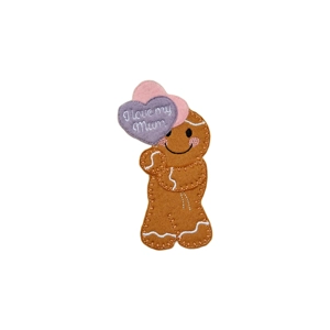 A felt gingerbread character holding two heart-shaped balloons, with the front balloon stitched with the words “I love my mum”.