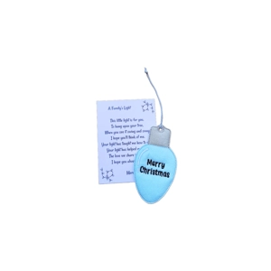 A light blue felt Christmas light bulb decoration with embroidered ‘Merry Christmas’ text, softly padded and finished with a silver felt top and hanging loop, displayed alongside a printed keepsake card titled ‘A Family’s Light’.