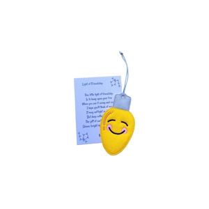 A yellow felt Christmas light bulb decoration with a smiling face design, softly padded and finished with a silver felt top and hanging loop, displayed alongside a printed keepsake card titled ‘Light of Friendship’.
