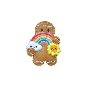 A felt gingerbread character holding a colourful embroidered rainbow, with a smiling yellow sun on one side and a small sad white cloud beneath the rainbow.