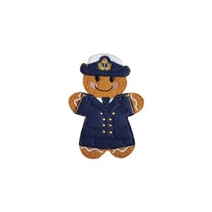 A felt gingerbread character dressed as a WREN officer, wearing a navy uniform with embroidered buttons and a peaked cap, with a smiling face and rosy cheeks.