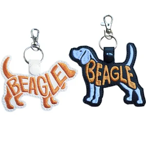 Black and white Beagle dog word art keyrings made from faux leather with embroidered Beagle lettering and sturdy metal keyring fittings.