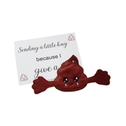 A cheeky poop pocket hug keyring with outstretched arms and embroidered smiling face, shown alongside a printed keepsake card that reads “Sending a little hug because I give a…”.