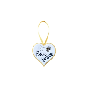White felt heart decoration with the words 'Bee brave' embroidered on the front and a small stitched bee above the text, finished with a neat yellow edge and a matching hanging ribbon.