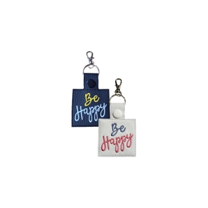 Two faux leather keyrings with clip fastenings, each embroidered with the words ‘Be Happy’. One keyring is black with yellow and light blue stitching, and the other is white with light purple and pink stitching. Both have a rectangular shape with a stitched finish and metal keyring clips.