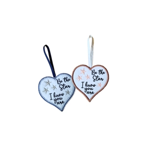 Two heart-shaped hanging decorations with embroidered stars and the message ‘Be the Star I know you are’. One has a navy blanket stitch border and navy ribbon, and the other has a rose-gold satin stitch border with a white ribbon loop.