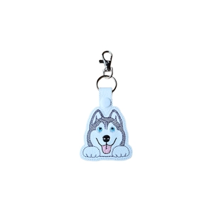 A kawaii-style husky dog keyring made from faux leather, featuring a smiling blue-eyed husky face with fluffy ears, machine embroidery, and a metal keyring with lobster clasp.