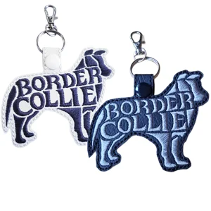 Black and white Border Collie dog word art keyrings made from faux leather with embroidered breed lettering and sturdy metal keyring fittings.