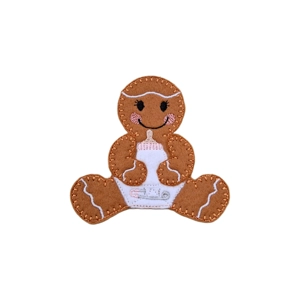 A felt gingerbread baby character wearing a white nappy with an embroidered safety pin and holding a baby bottle.
