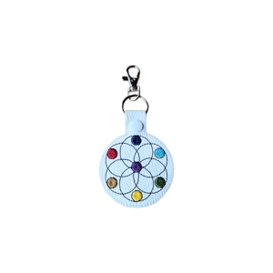 A circular faux leather keyring with machine embroidered interlocking circles and seven coloured dots representing the chakras, finished with a metal clasp and split ring.