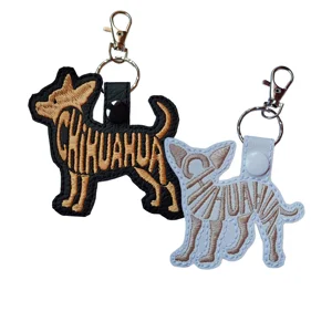 Black and white Chihuahua word art keyrings with brown embroidered details, shown with metal keyrings and clasps.