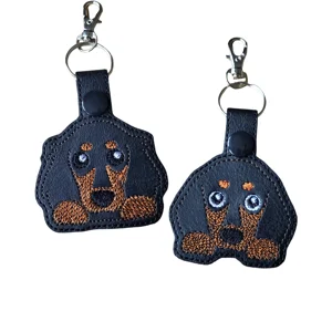 Cute dachshund dog keyrings in two designs, short haired and long haired, made from black faux leather with brown embroidery, keyring and lobster clasp.