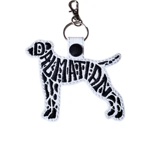 Dalmatian word art keyring made from white faux leather with black embroidery, metal keyring and lobster clasp fitting.