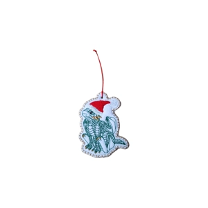 A felt baby dragon Christmas ornament with green embroidered scales and wings, wearing a red and white Santa hat, finished with a red hanging cord and decorative stitched edging.