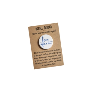 A round 38 mm needle minder with the handwritten words “free spirit”, displayed on a brown kraft backing card with needle minder instructions printed in black.