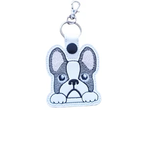 French Bulldog keyring made from white faux leather with big perky ears, pink stitched details, bright embroidered eyes, pouty face, keyring and lobster clasp.