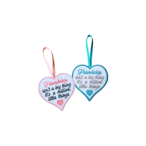 Two handmade felt heart decorations with ribbon hangers, each embroidered with the quote 'Friendship isn't a big thing, it is a million little things'. One heart has a pink border with a pink stitched heart, and the other has a turquoise border with a turquoise stitched heart.