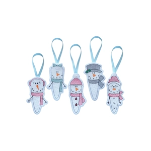 A row of five embroidered icicle-shaped snowman ornaments made from felt, each with a smiling face and cosy winter accessories, hanging from pale blue ribbon loops.