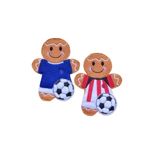 Two felt gingerbread football player characters, each with a smiling face and rosy cheeks. One wears a blue football kit, and the other wears a red and white striped kit. Both are holding a black and white football at their feet.