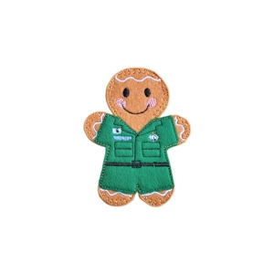 Handmade felt Gingerbread Paramedic Character wearing a green paramedic uniform with embroidered details, smiling face, and stitched icing accents.