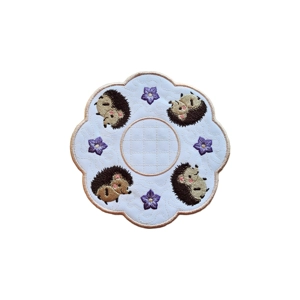 Embroidered Hedgehog Decorative Table Mat featuring four cute hedgehogs surrounded by purple flowers, on a white background with a soft rose gold border.