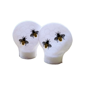 Set of two white felt tealight covers embroidered with honey bees and a subtle honeycomb pattern, designed to fit over flameless candles.