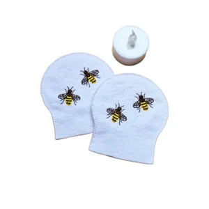 Pair of Honey Bee embroidered felt tealight covers shown with a standard LED tealight, designed for soft country garden decor.
