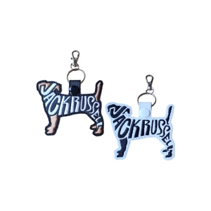 Two embroidered Jack Russell silhouette keyrings, one black and one white, with word-art stitching and metal clasps.