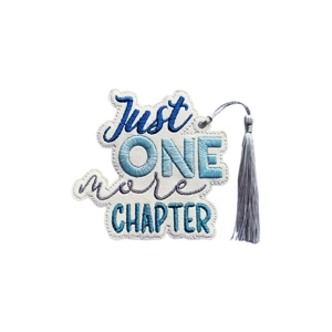 Handmade faux leather bookmark embroidered with the words Just One More Chapter, featuring a coordinating tassel and crafted in soft blue tones.