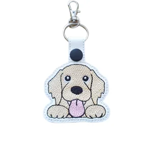 Kawaii golden retriever dog keyring with embroidered floppy ears, bright eyes, black nose and pink tongue, finished with silver keyring and lobster clasp.