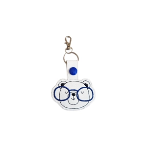 Embroidered bear keyring wearing oversized glasses, made from faux leather and attached to a metal keyring clasp.