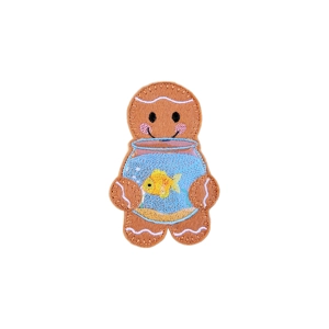 A felt gingerbread character holding a fishbowl with an embroidered goldfish inside, stitched smile and rosy cheeks.