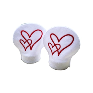 Two white heart-shaped tealight covers with red embroidered heart motifs, designed to fit over LED tealights.