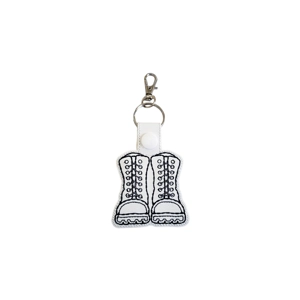 Miniature Military Combat Boots Keyring made of faux leather with detailed lace-up embroidery and treaded soles, featuring a metal swivel clasp and snap fastening, suitable as a gift or stylish accessory for keys, bags, or backpacks.