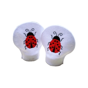 Two white felt LED tealight covers featuring embroidered red ladybirds with black details, designed to sit over standard LED tealights and create a softly diffused decorative glow.
